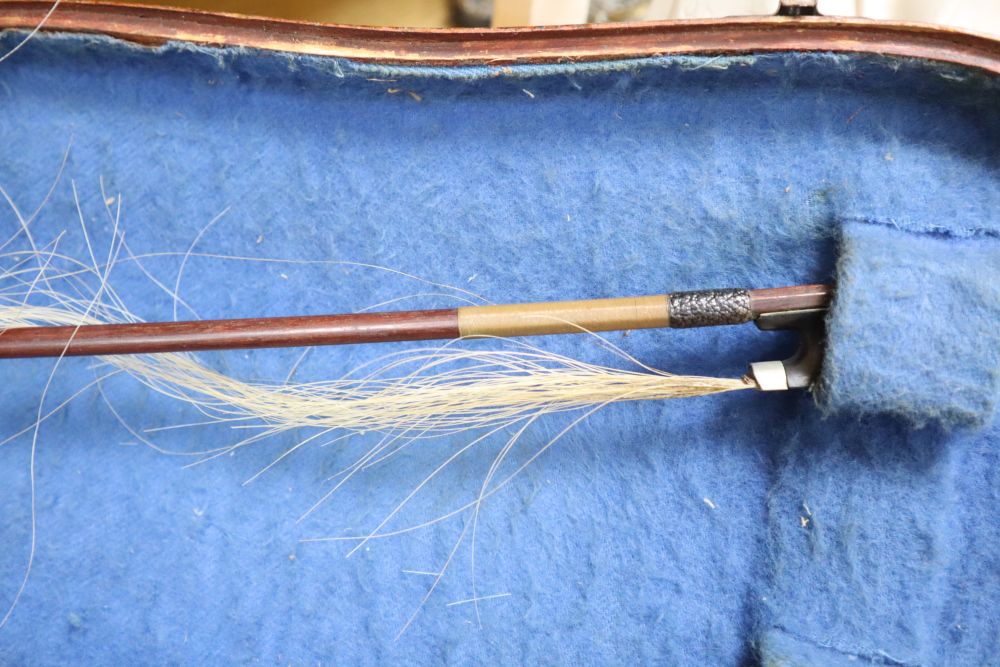 A cased violin, labelled Buthod, Paris, length of back 36cm, with bow stamped Tourte